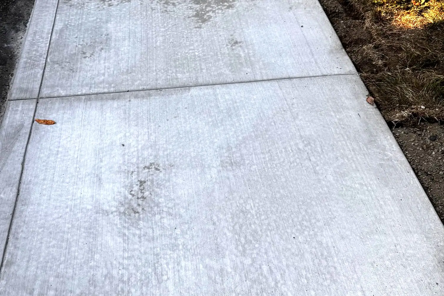 New broom finish concrete sidewalk with smooth tooled edges