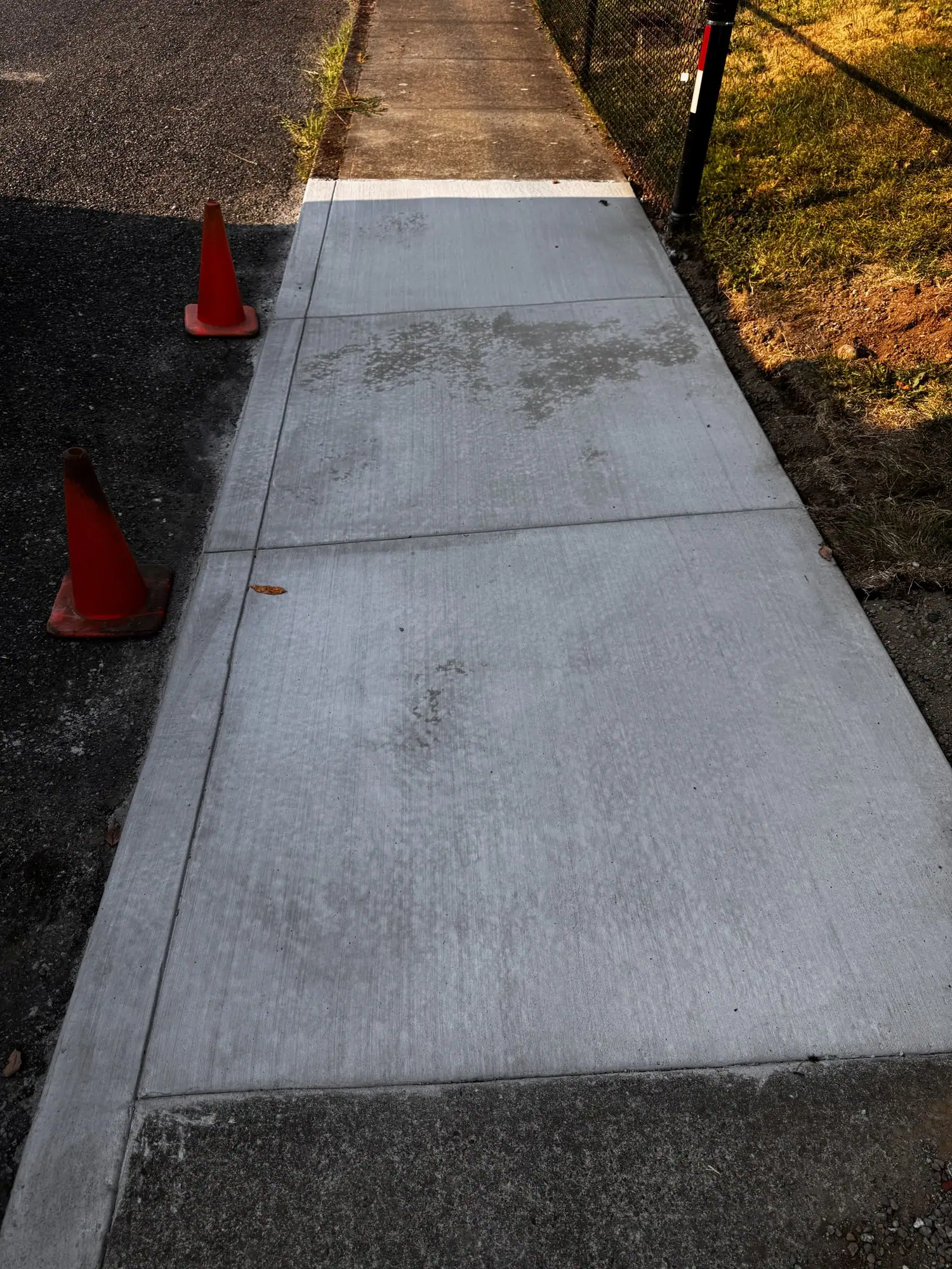 New broom finish concrete sidewalk with smooth tooled edges