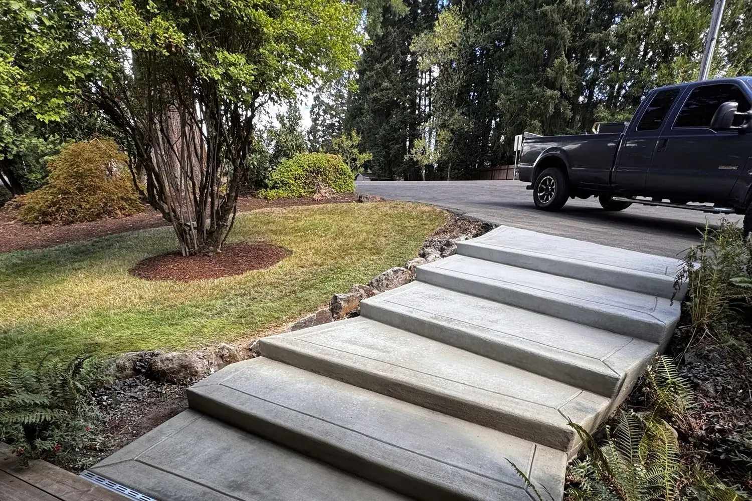 Concrete steps down through a sloped front yard