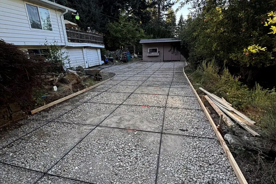 Long exposed aggregate driveway leading back to a detached garage
