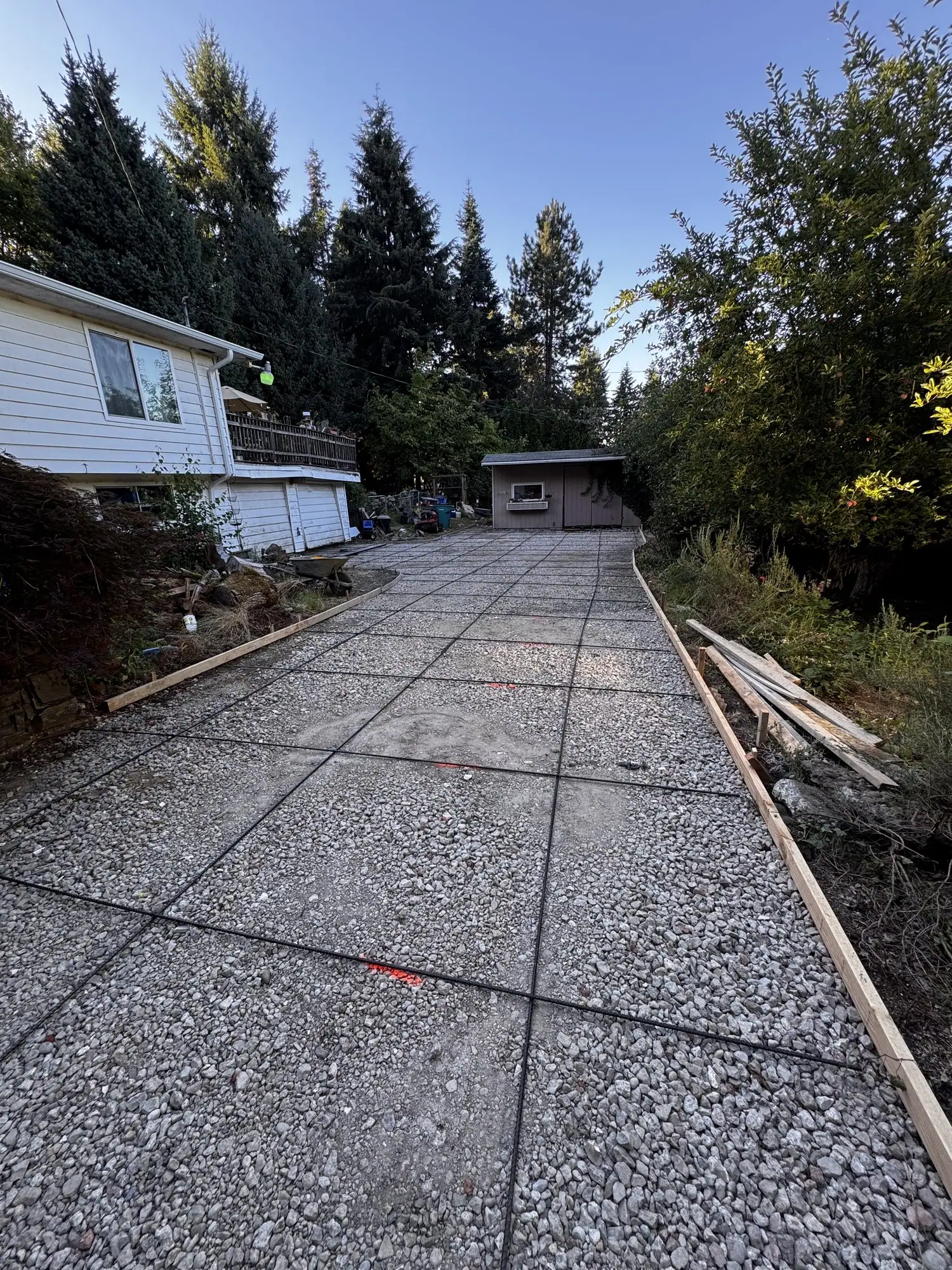Long exposed aggregate driveway leading back to a detached garage