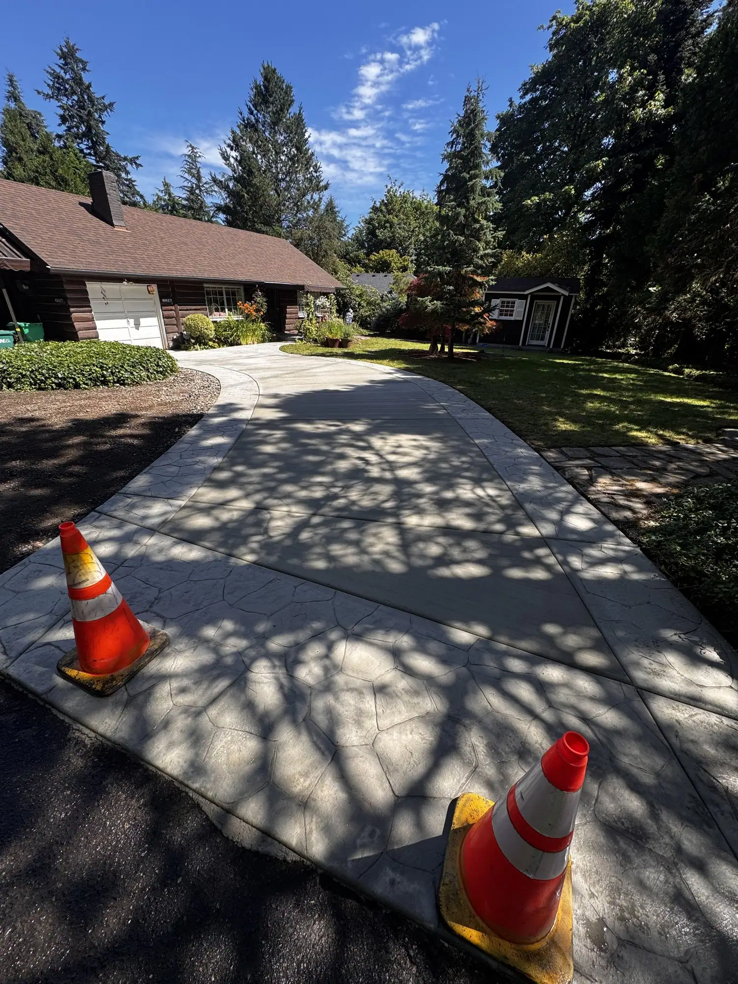New broom finish concrete driveway coned off while it cures