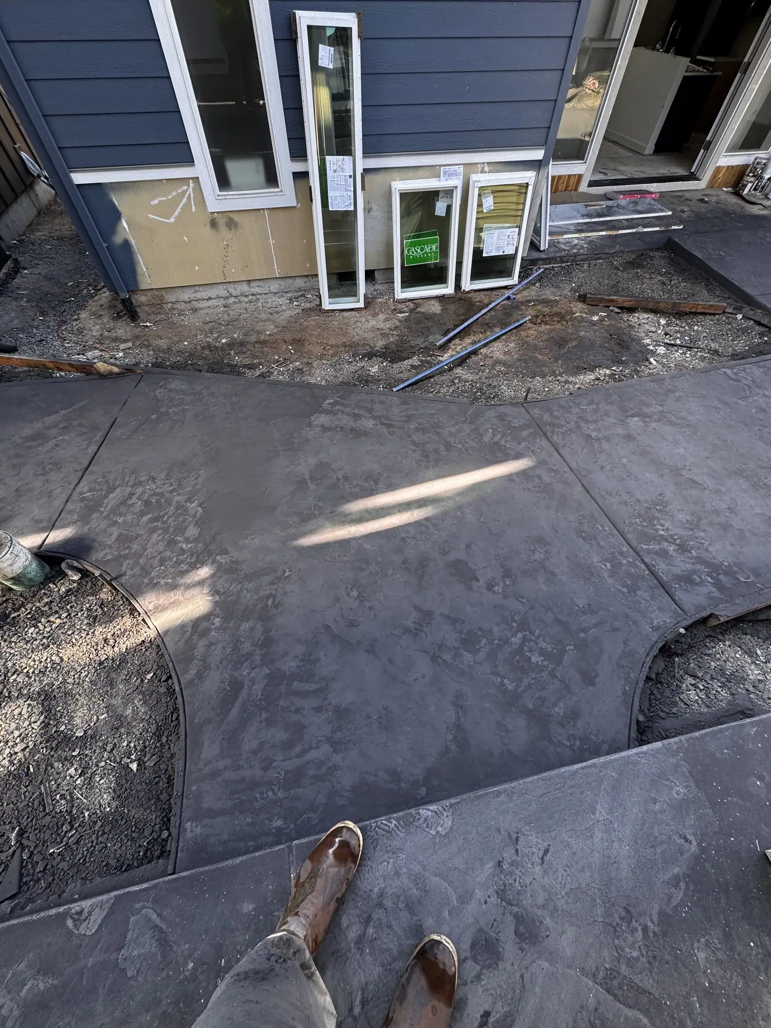 Stamped concrete patio with a stone texture outside a sliding door