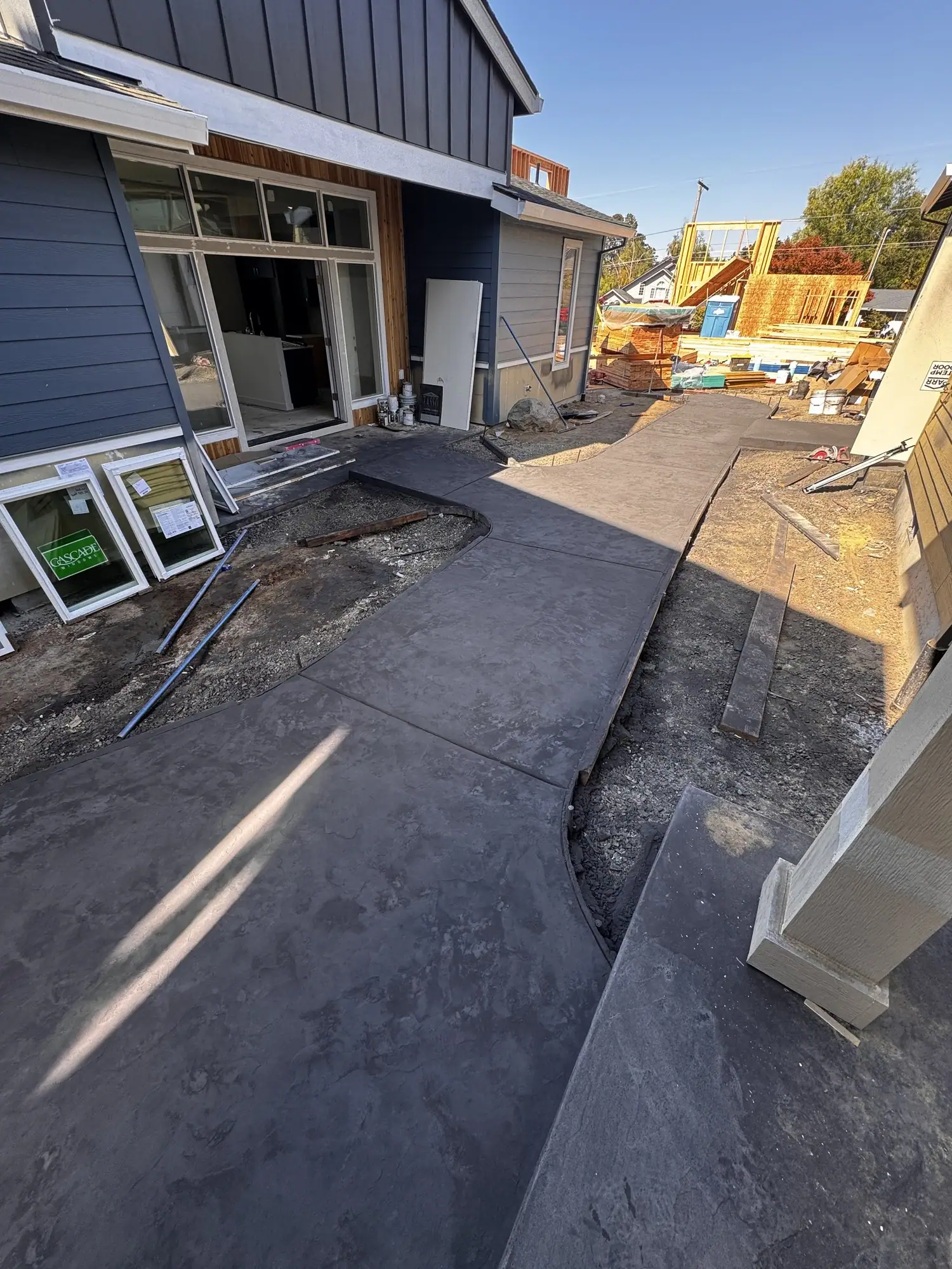 Stamped concrete patio wrapping around the side of a house
