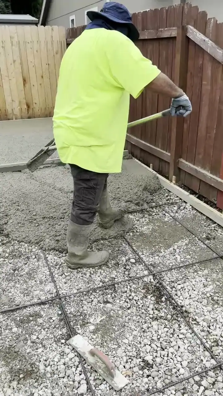 MJ Concrete crew working a fresh exposed aggregate slab